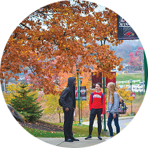 Students walking across La Roche University's campus in autumn